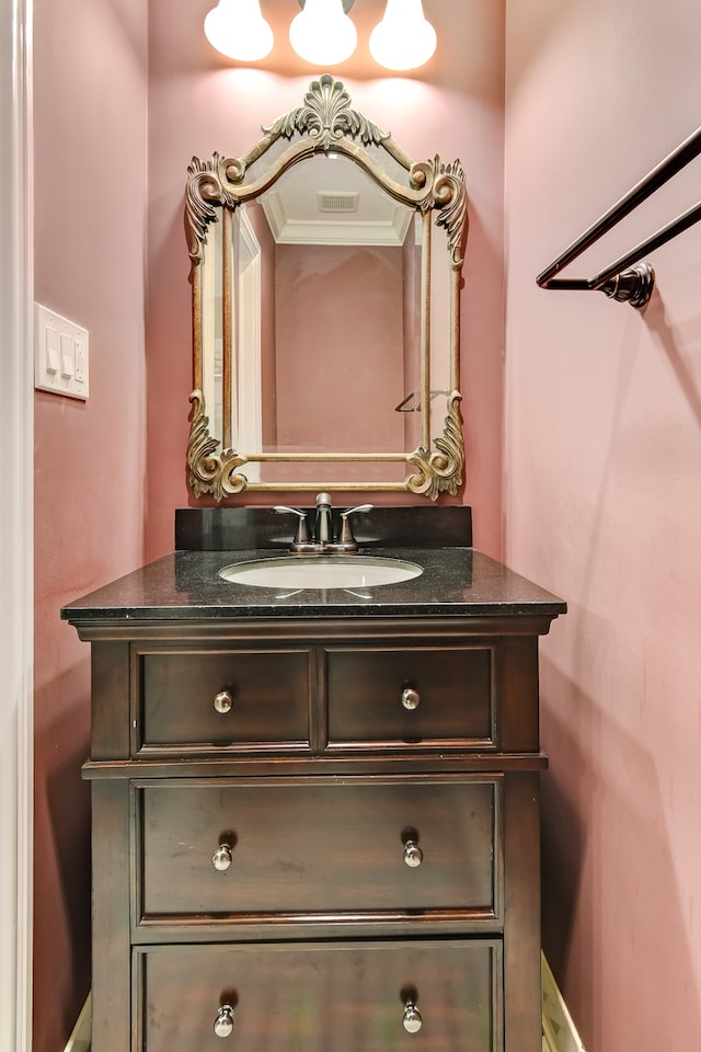 bathroom with crown molding and vanity