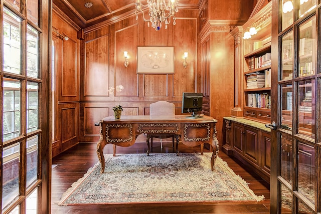 office space with a chandelier, wooden walls, a healthy amount of sunlight, and dark hardwood / wood-style flooring