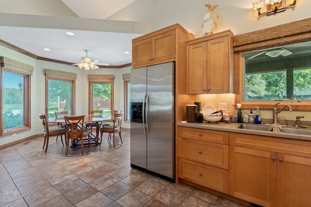 kitchen featuring stainless steel fridge, sink, ceiling fan, ornamental molding, and tile flooring