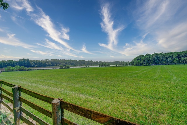 view of yard with a rural view and a water view