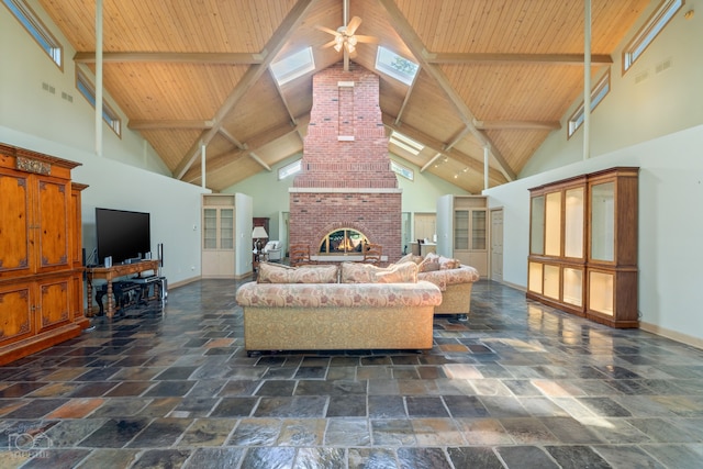 interior space with high vaulted ceiling, a brick fireplace, beam ceiling, and ceiling fan