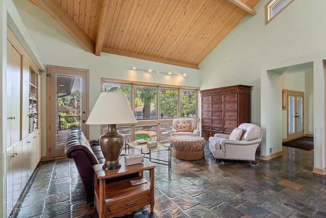 living room with wooden ceiling, high vaulted ceiling, dark tile floors, and beamed ceiling