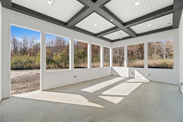 unfurnished sunroom with beam ceiling and coffered ceiling