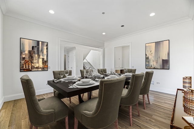 dining room with wood-type flooring and crown molding