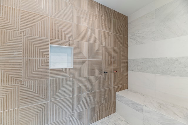 bathroom with walk in shower and tile walls