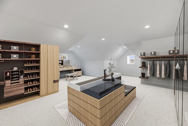 home office with light carpet and vaulted ceiling