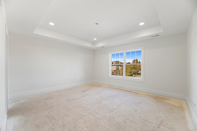 empty room featuring a tray ceiling