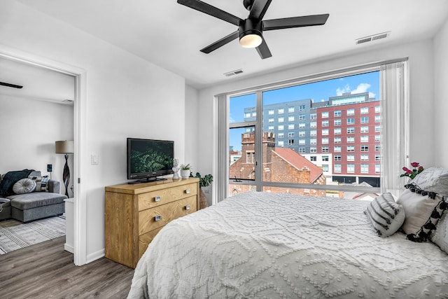 bedroom with ceiling fan and hardwood / wood-style flooring