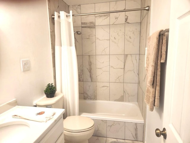 bathroom featuring vanity, toilet, and tiled shower / bath combo