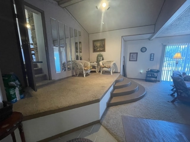 living room featuring lofted ceiling and light tile flooring