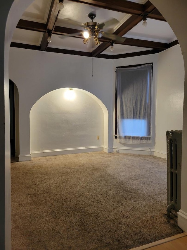 interior space with arched walkways, beamed ceiling, coffered ceiling, and radiator