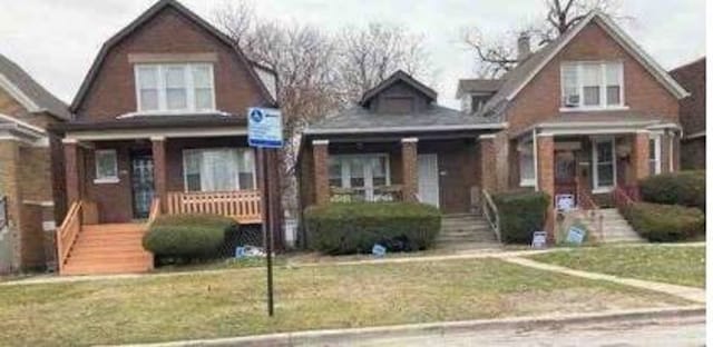 bungalow-style home with a front yard and a porch