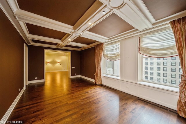 unfurnished room featuring coffered ceiling, ornamental molding, and dark wood-type flooring