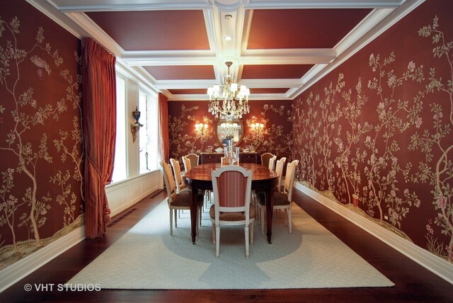 dining space featuring coffered ceiling, beam ceiling, a chandelier, crown molding, and dark hardwood / wood-style flooring