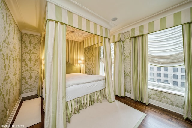 bedroom with ornamental molding, dark wood-type flooring, and multiple windows