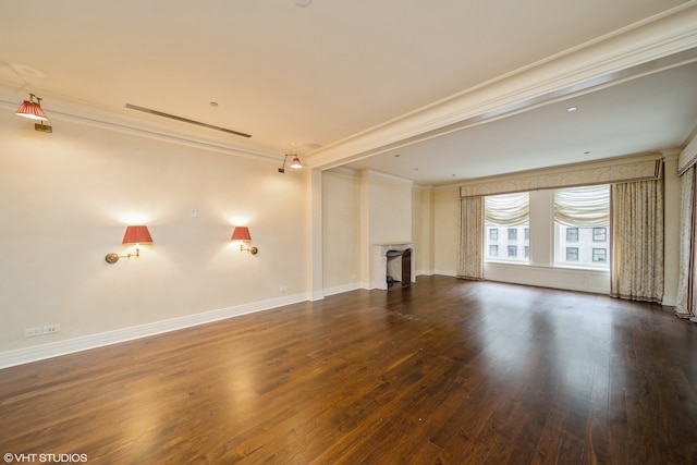 spare room featuring crown molding and dark hardwood / wood-style flooring