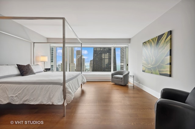 bedroom with dark wood-type flooring