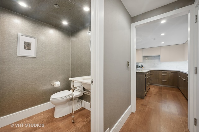 bathroom featuring vanity, toilet, and hardwood / wood-style flooring