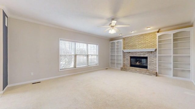 unfurnished living room with ceiling fan, brick wall, a brick fireplace, light carpet, and ornamental molding