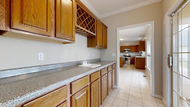 kitchen featuring sink, stainless steel appliances, light tile floors, light stone counters, and ornamental molding