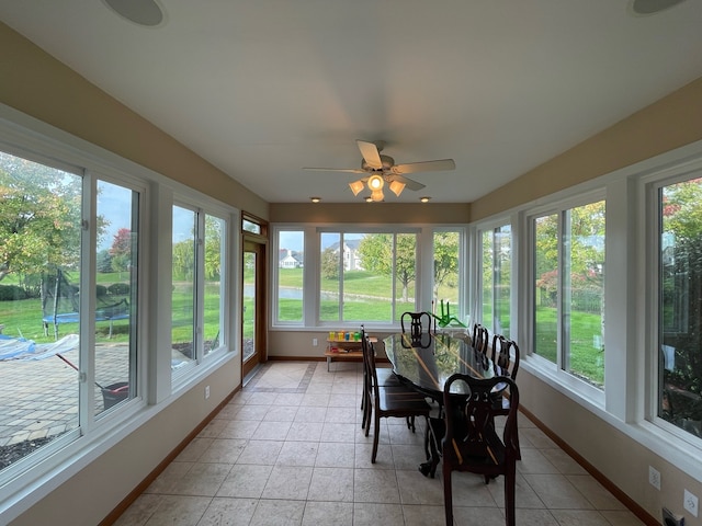 sunroom / solarium featuring ceiling fan