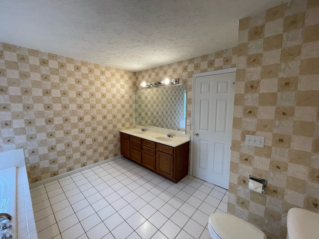 bathroom with vanity, a textured ceiling, tile flooring, and toilet