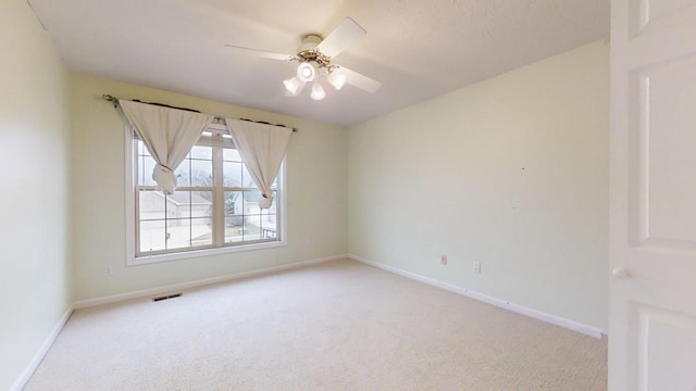 carpeted empty room with ceiling fan