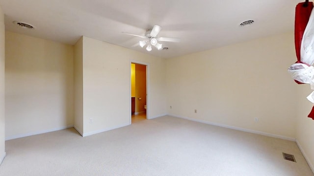 carpeted empty room featuring ceiling fan