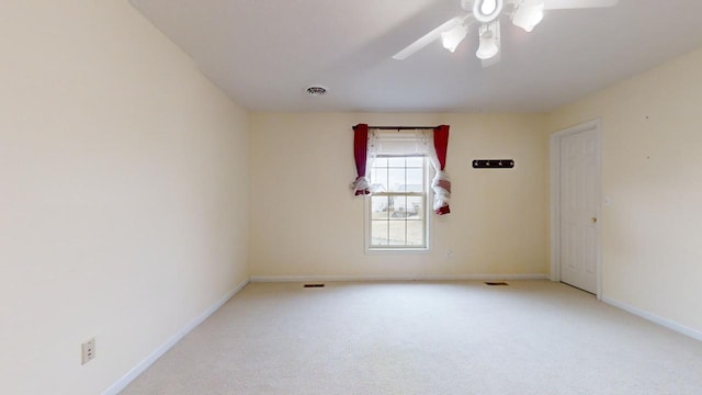 carpeted empty room featuring ceiling fan