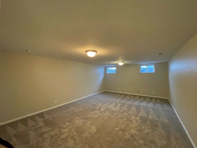 basement featuring dark colored carpet