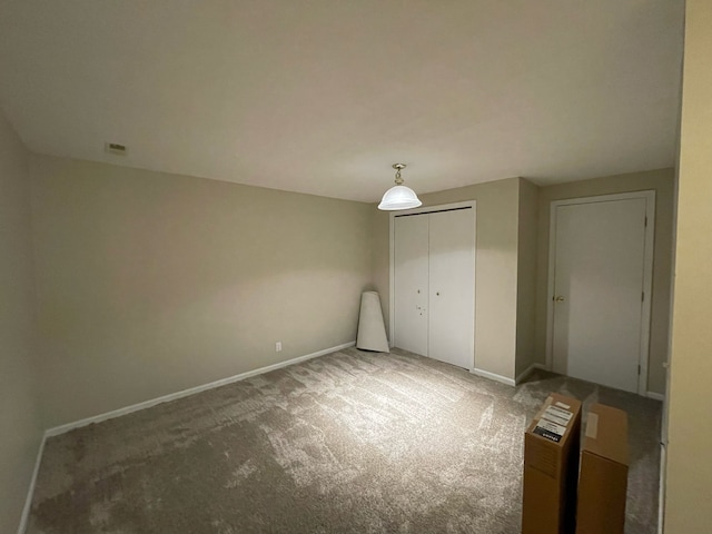 unfurnished bedroom featuring carpet flooring and a closet