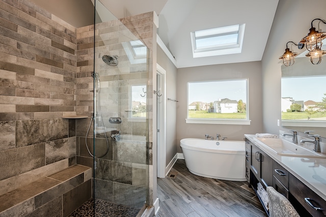 bathroom featuring shower with separate bathtub, plenty of natural light, and wood-type flooring