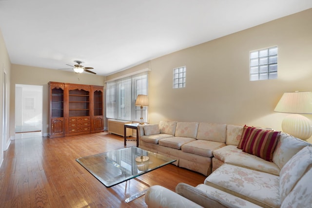 living room featuring ceiling fan and light hardwood / wood-style flooring