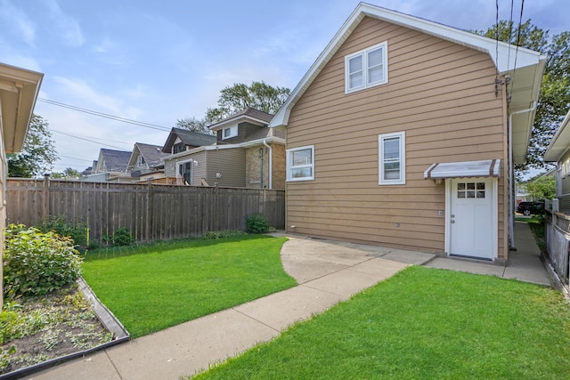 rear view of property with a lawn