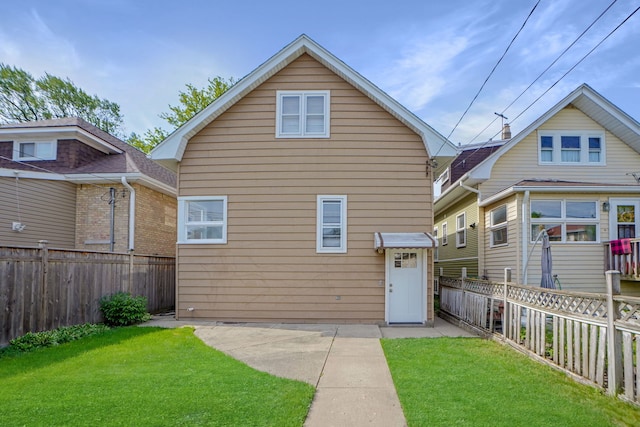 back of property featuring a yard