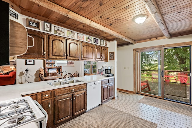 kitchen featuring wooden ceiling, beamed ceiling, dishwasher, sink, and light tile flooring