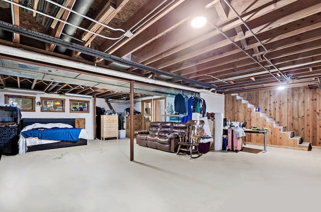 basement featuring wooden walls