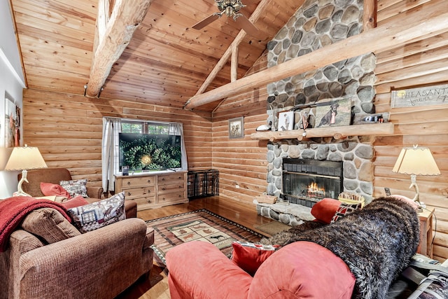 living room with ceiling fan, wood ceiling, light hardwood / wood-style floors, high vaulted ceiling, and a stone fireplace