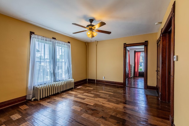 616 N Pleasant St, Princeton, IL 61356 - spare room with radiator heating unit, healthy amount of natural light, dark wood-style floors, and ceiling fan