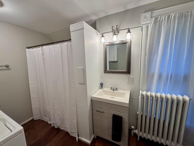 616 N Pleasant St, Princeton, IL 61356 - full bath with radiator, wood finished floors, vanity, and a shower with curtain