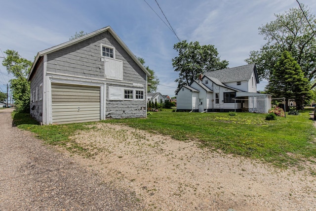 616 N Pleasant St, Princeton, IL 61356 - view of side of property featuring a garage, driveway, and a lawn