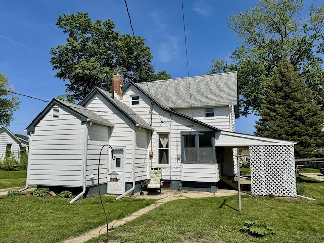 616 N Pleasant St, Princeton, IL 61356 - rear view of house with a lawn, a chimney, roof with shingles, and entry steps