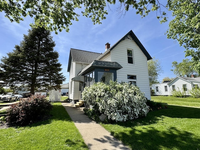 616 N Pleasant St, Princeton, IL 61356 - view of front facade with a shingled roof, a front lawn, a chimney, and entry steps