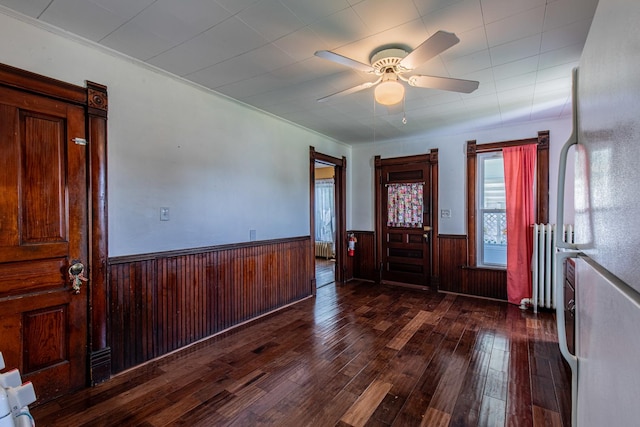616 N Pleasant St, Princeton, IL 61356 - entryway with dark wood finished floors, wainscoting, ceiling fan, and wood walls