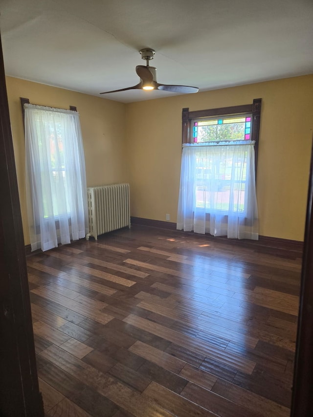 616 N Pleasant St, Princeton, IL 61356 - unfurnished room with radiator heating unit, a ceiling fan, and wood finished floors