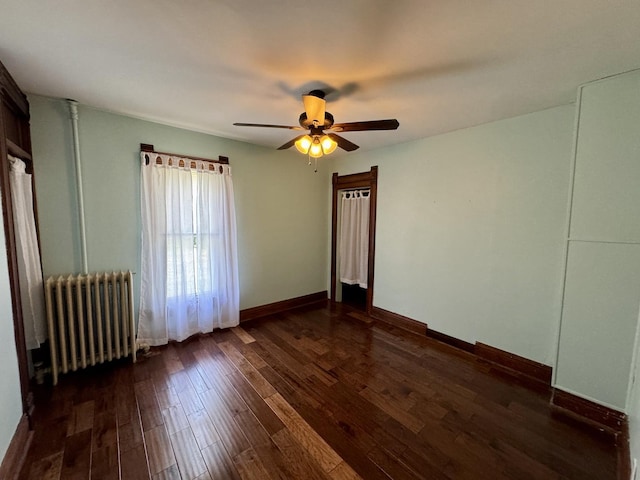 616 N Pleasant St, Princeton, IL 61356 - spare room featuring radiator heating unit, dark wood finished floors, and a ceiling fan