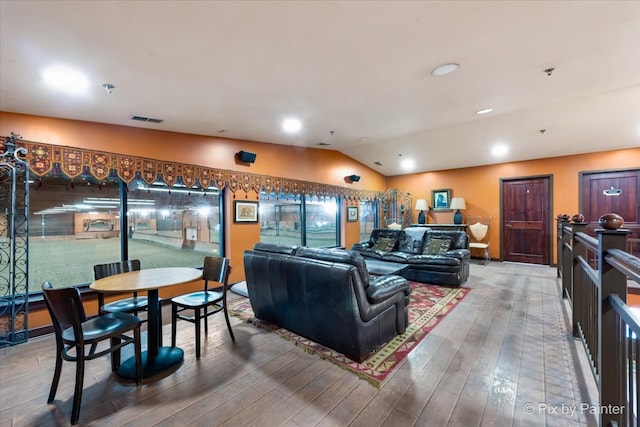 living room featuring lofted ceiling and wood-type flooring