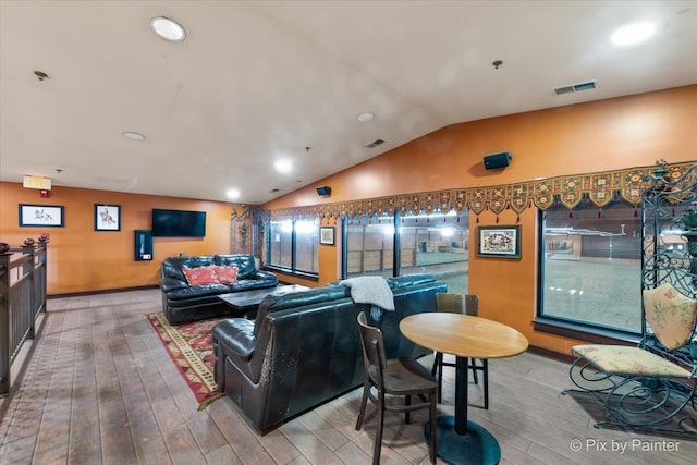 living room with lofted ceiling and light hardwood / wood-style flooring