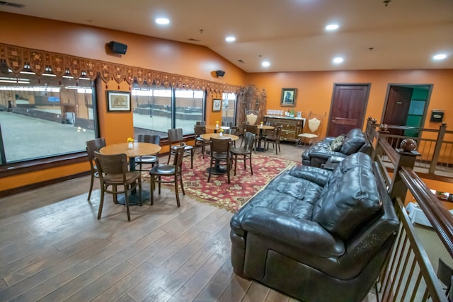 living room with vaulted ceiling and hardwood / wood-style floors