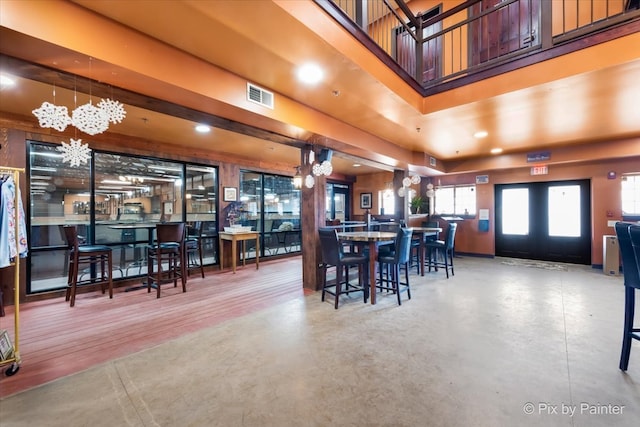 dining area featuring french doors and an inviting chandelier